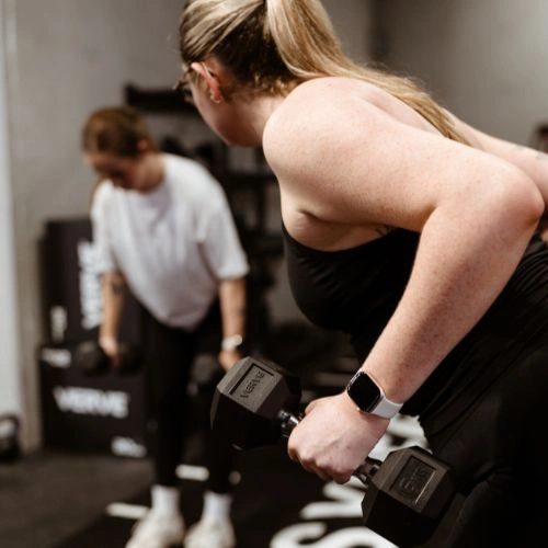 Women lifting weights in group fitness class in wyong